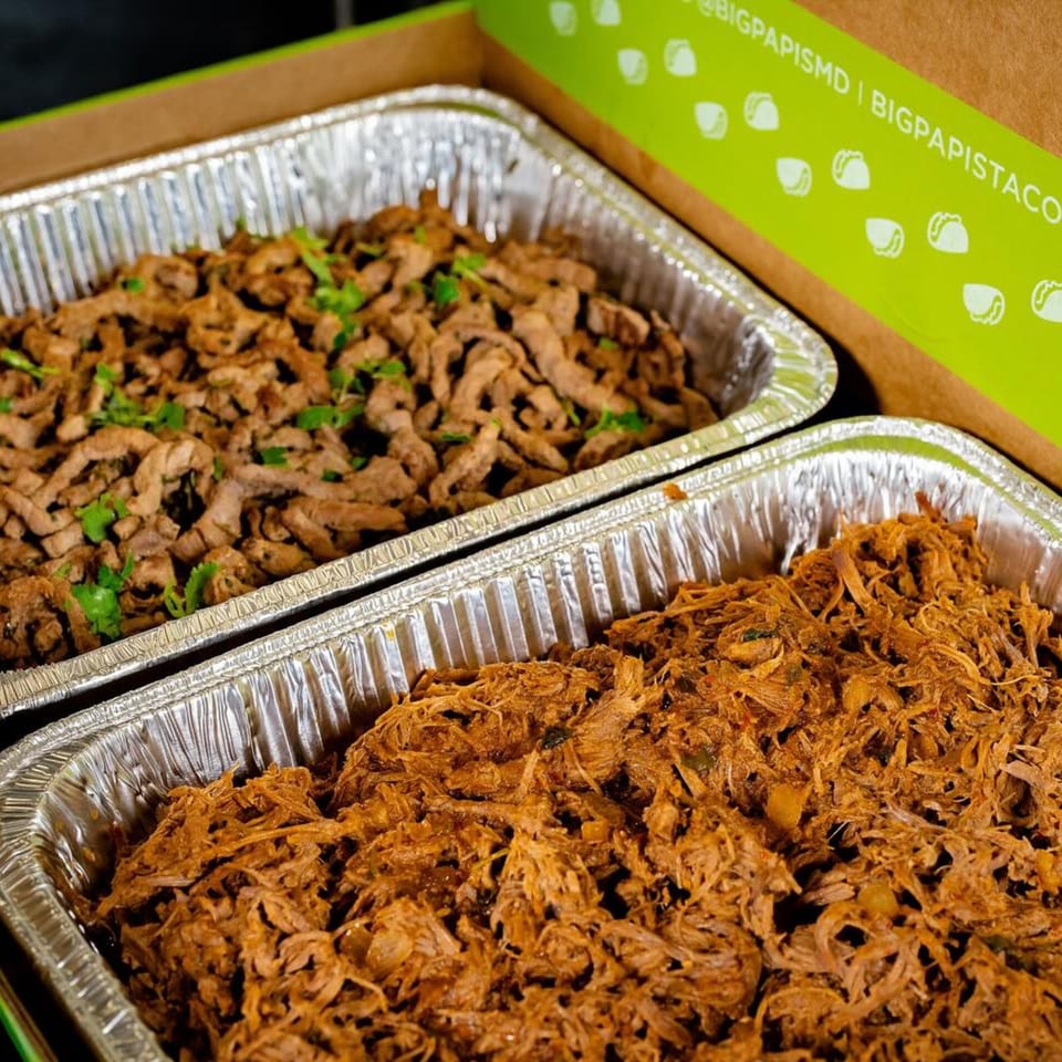 Two foil trays of Big Papi's Mexican meats, one with shredded beef, the other with steak.