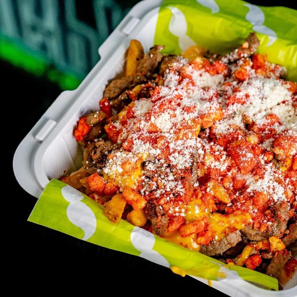 Big Papi's carne asada fries topped with cheese, Hot Cheetos, and cotija cheese.